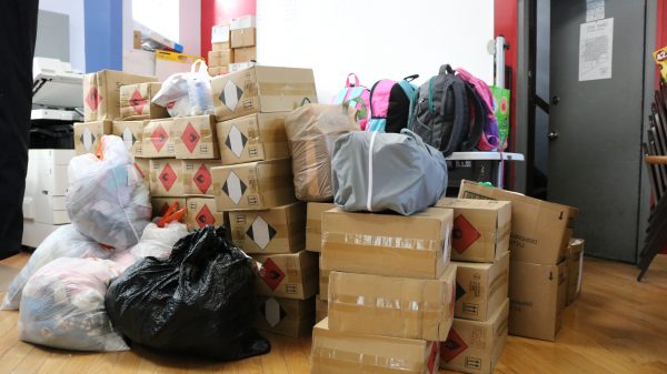 Cardboard boxes, garbage bags and backpacks full of donations are piled up in the corner of an alderman's office