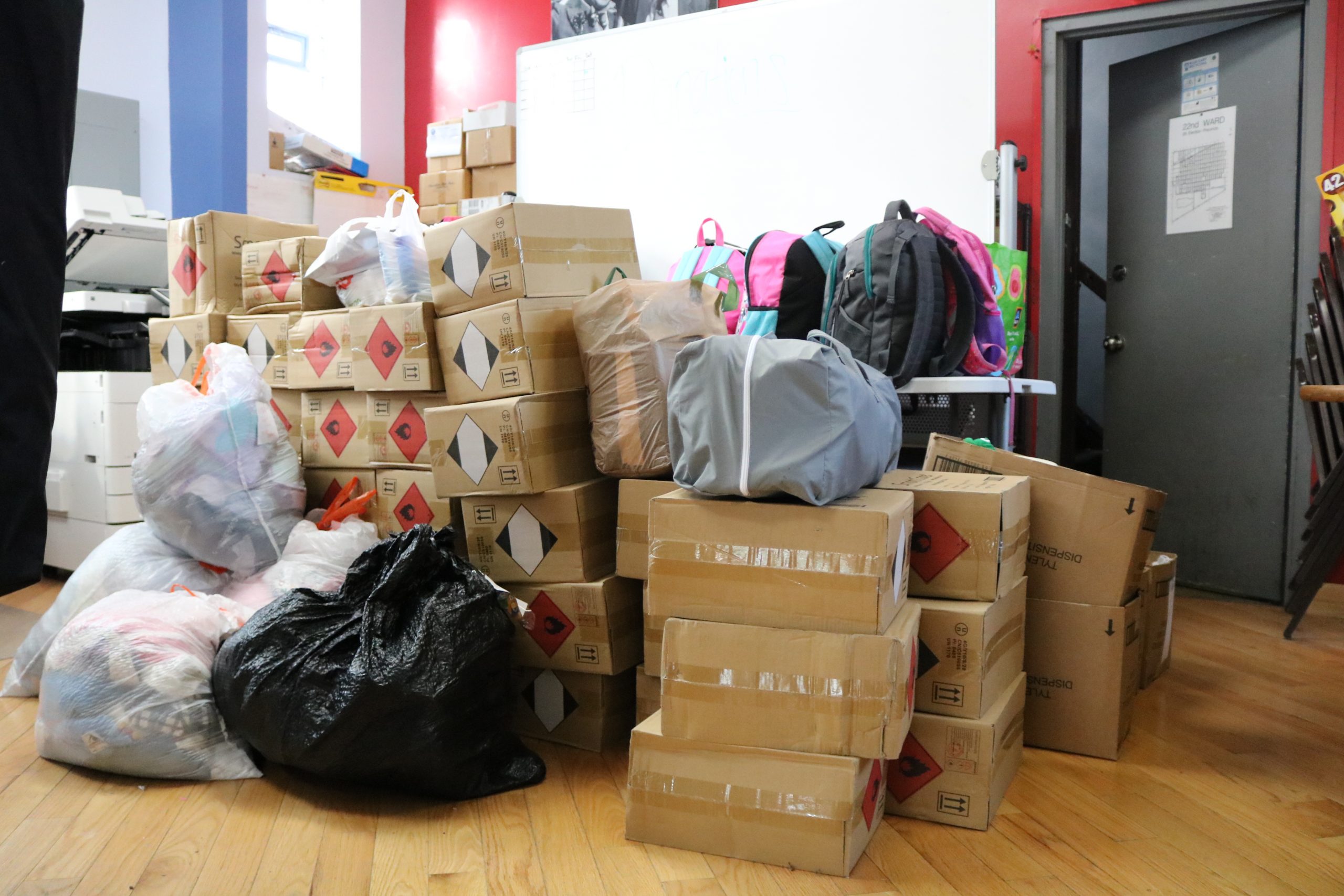 Cardboard boxes, garbage bags and backpacks full of donations are piled up in the corner of an alderman's office